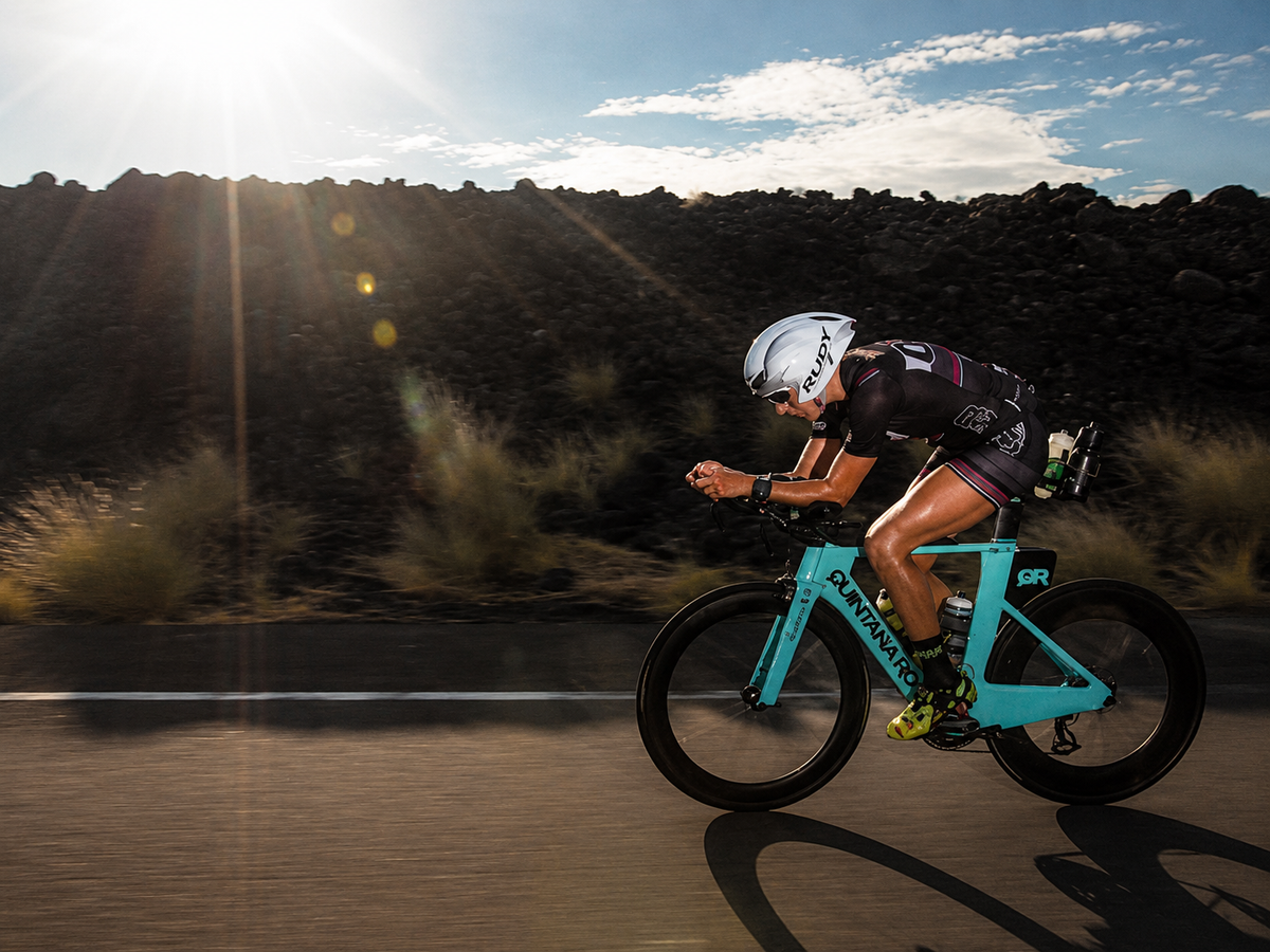 QT2 Systems athlete riding through Kona lava fields